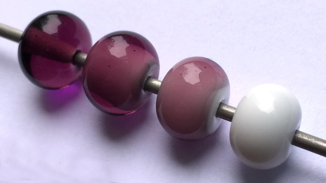 Purple and white layered glass beads