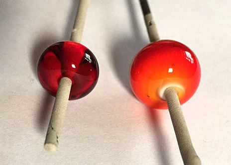 Handmade red glass beads made with striking glass